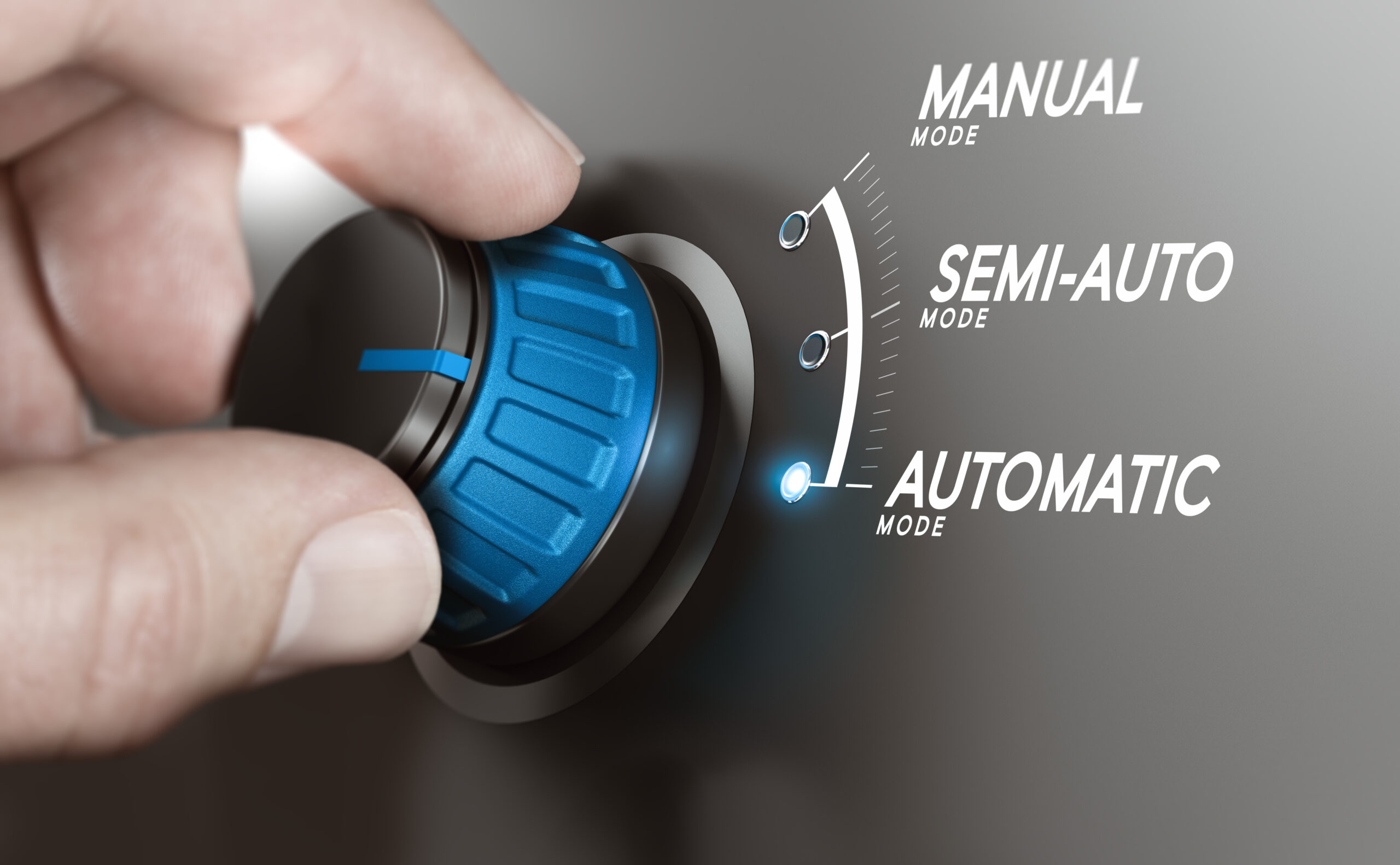 Hand turning a knob over grey background and selecting the automatic mode. Manufacturing process automation or automatic testing concept. Composite image between a hand photography and a 3D background.