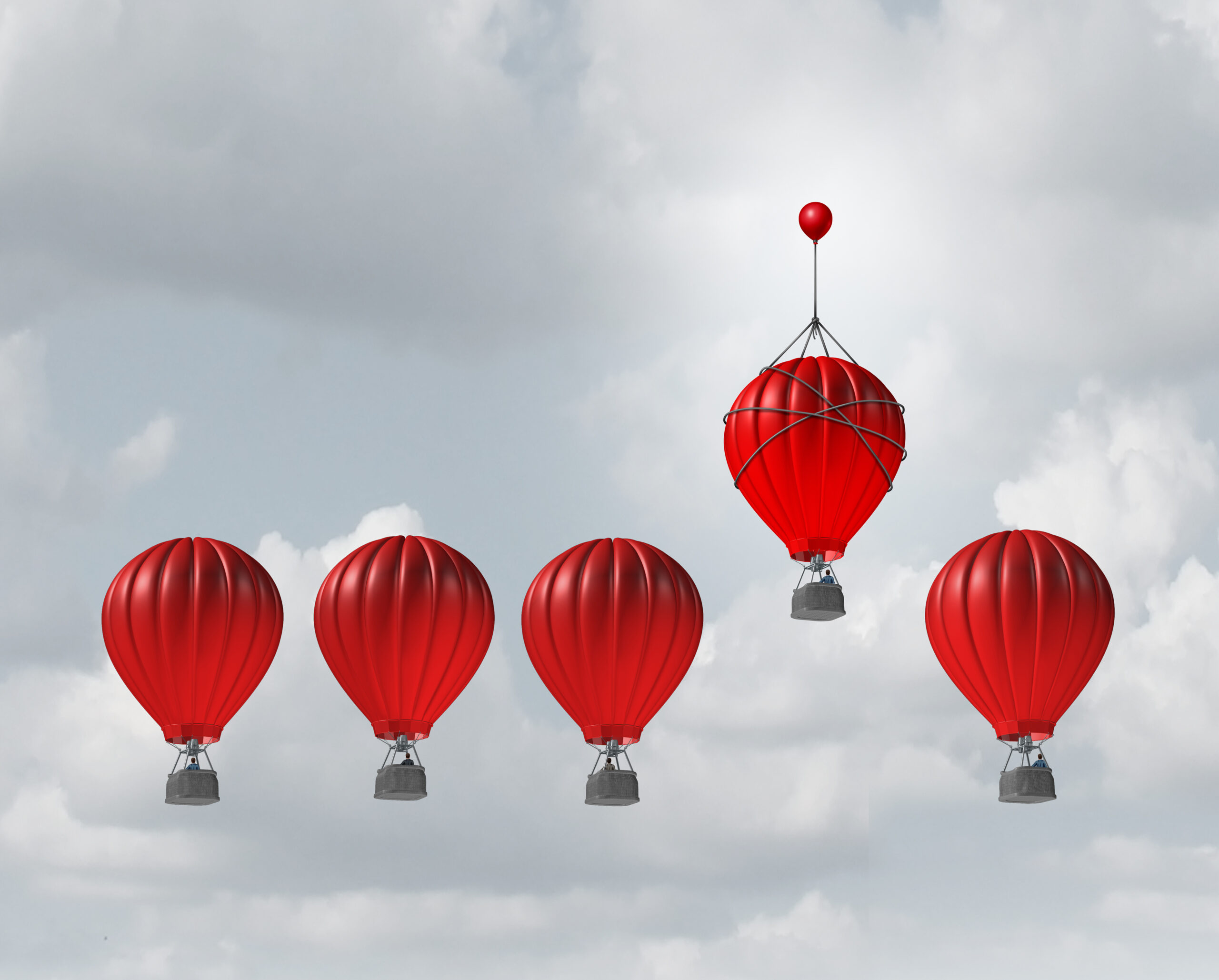 Competitive edge and business advantage concept as a group of hot air balloons racing to the top but an individual leader with a small balloon attached giving the winning competitor an extra boost to win the competition.